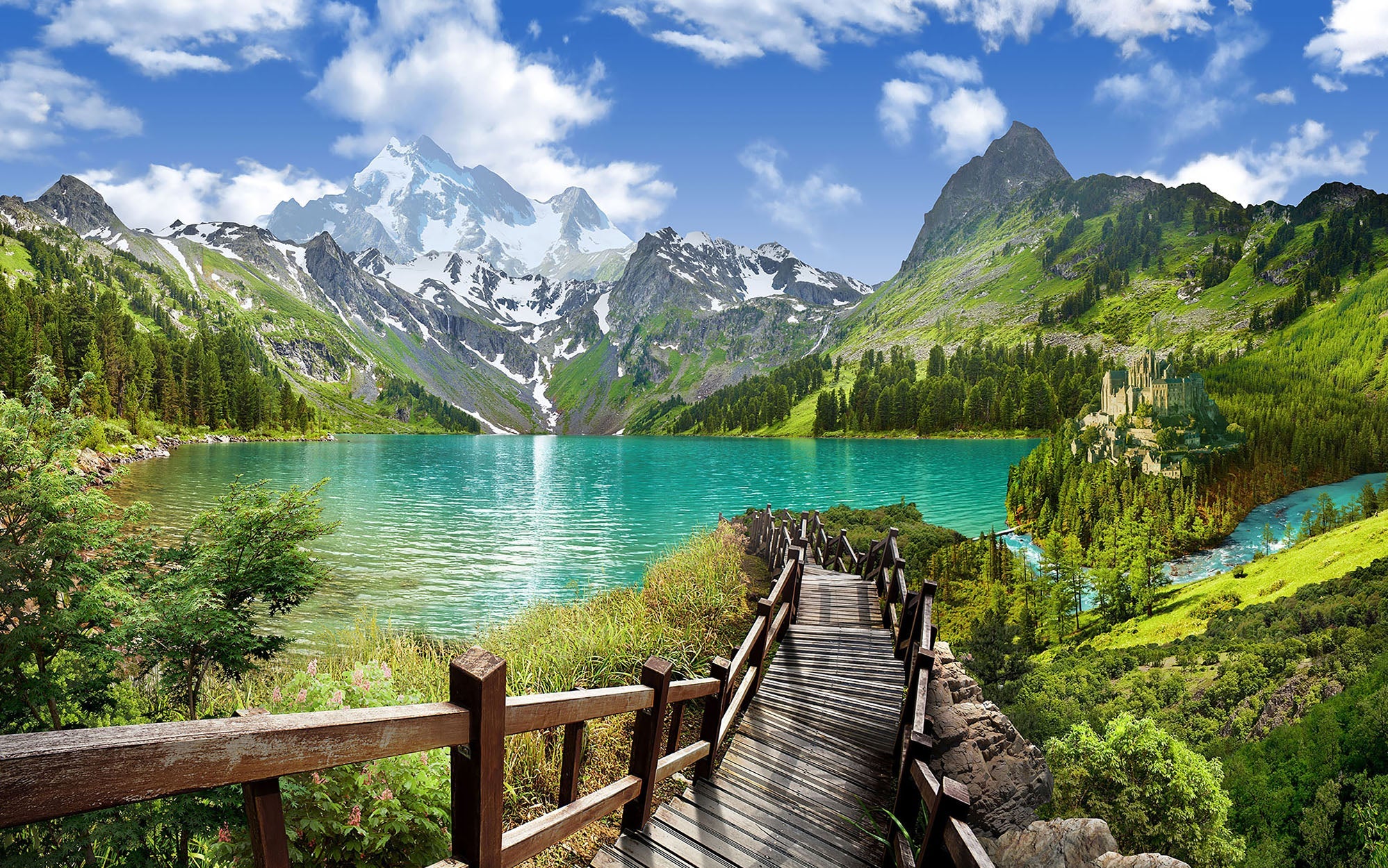 Wall mural of a scenic mountain lake with a wooden walkway leading towards it, depicting vibrant greenery and snow-capped mountains in the background