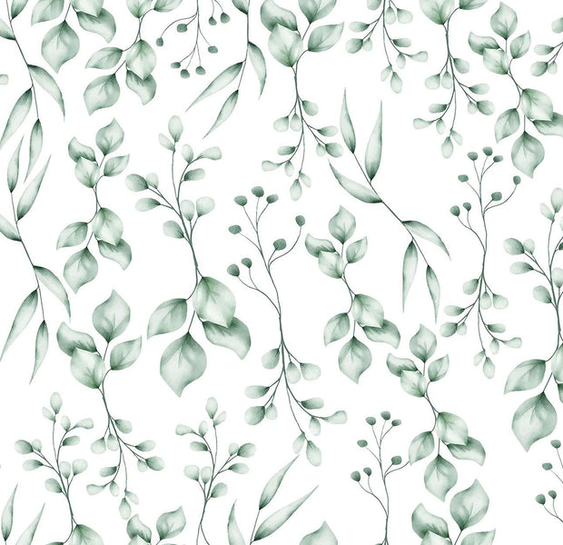 Green and white botanical patterns with leaves and berries on a wall mural in an interior setting