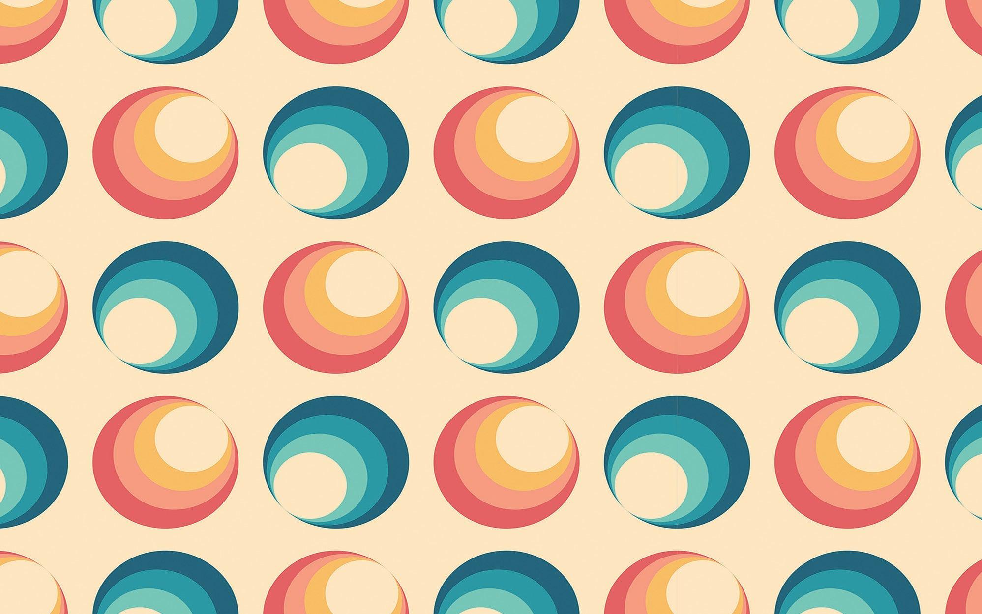 A wall covered with a retro-style mural featuring overlapping circles in various pastel colors
