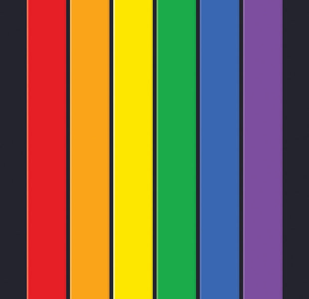 A vibrant wall mural with vertical stripes in red, orange, yellow, green, and purple on a dark background