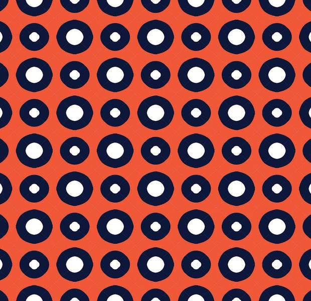 A vibrant wall mural featuring a geometric pattern with red background and blue circles with white centers