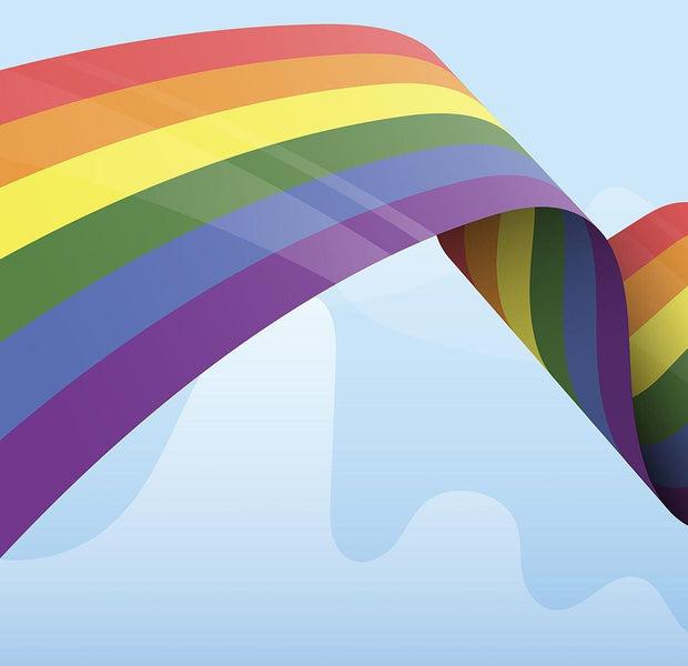 A colorful wall mural featuring a large painted rainbow against a blue background with cloud patterns.