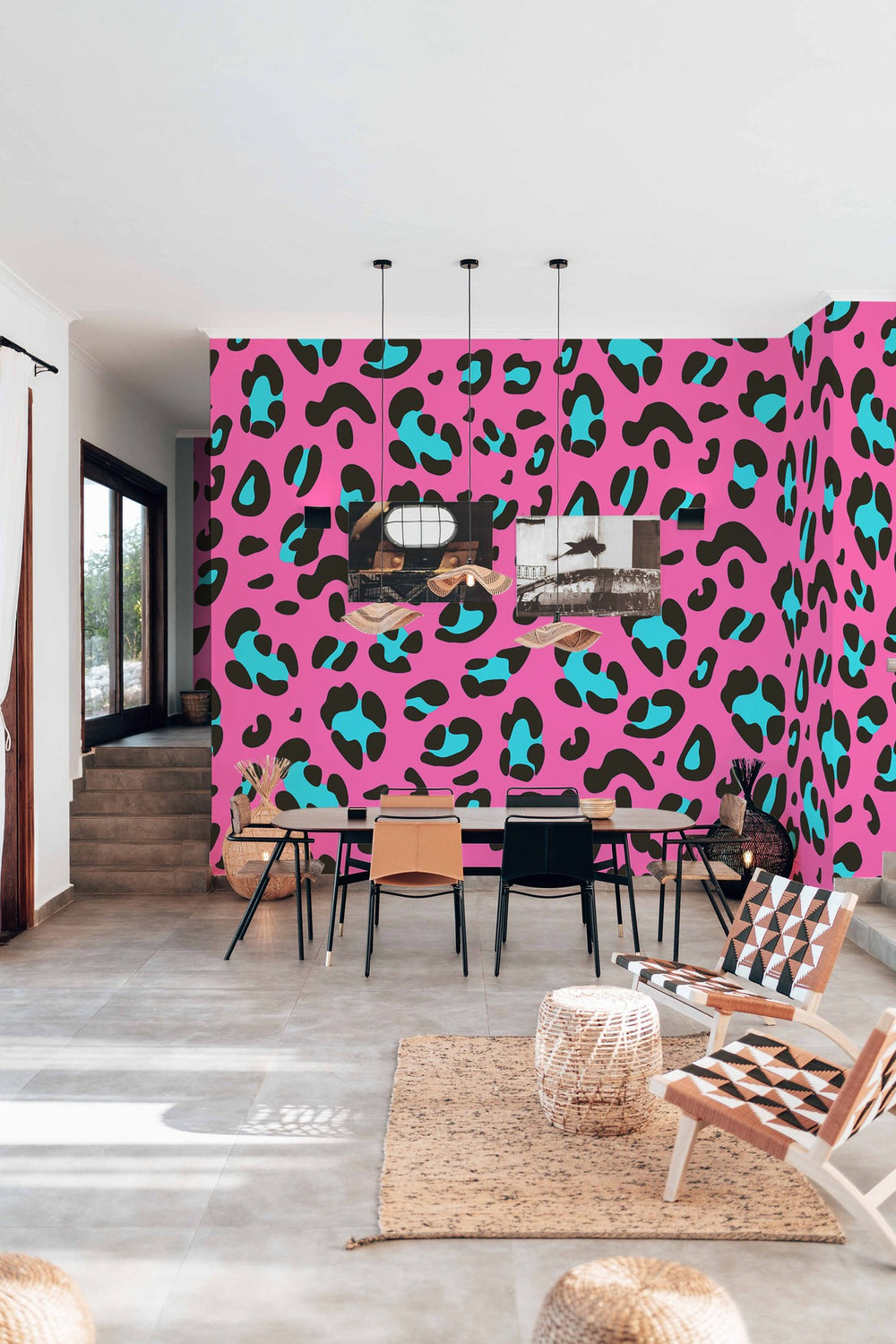 Dining room interior featuring a vibrant pink wall with large leopard print mural design, modern furniture, and decorative plants.