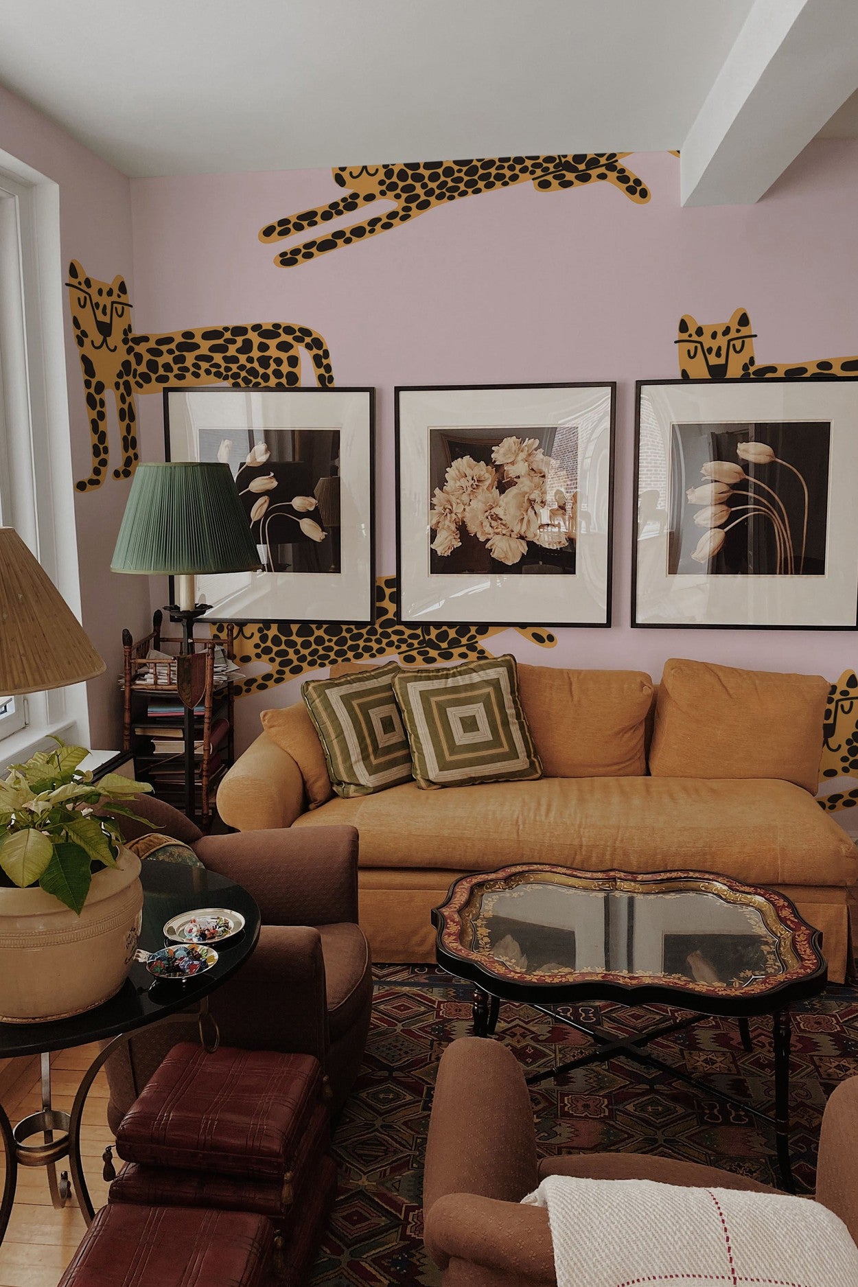A cozy living room interior with cheetah print mural accents on the walls and a warm-toned decor.
