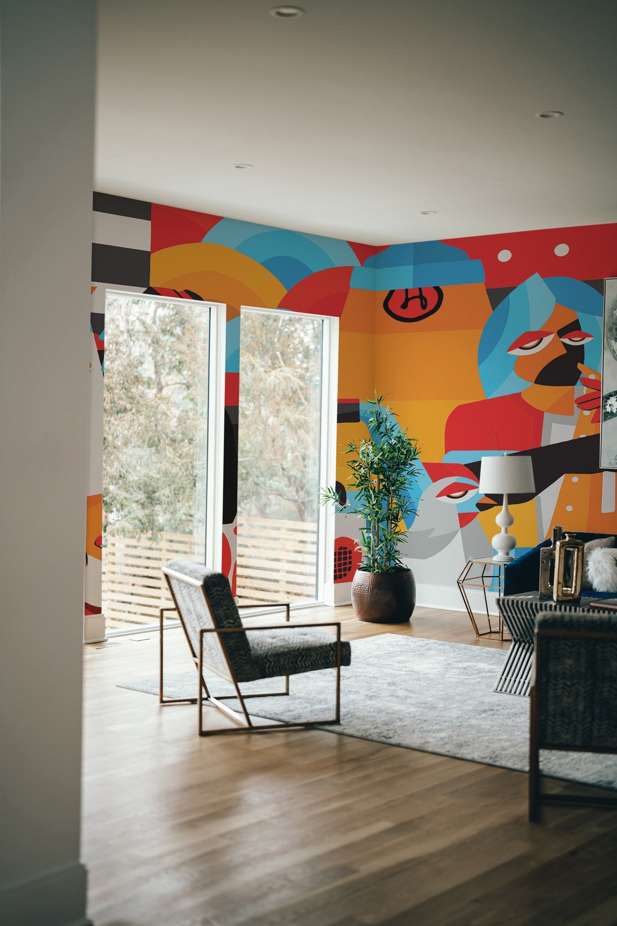 Interior room with modern abstract wall mural, armchair, and houseplant