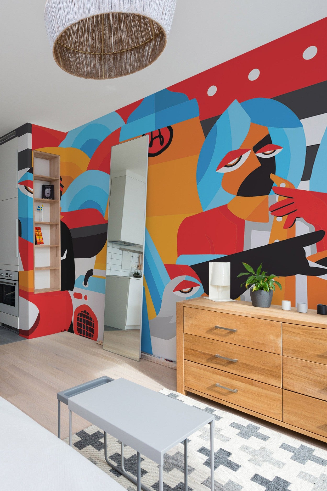 Modern kitchen interior with a vibrant pop art wall mural, wooden cabinets, and contemporary furniture.