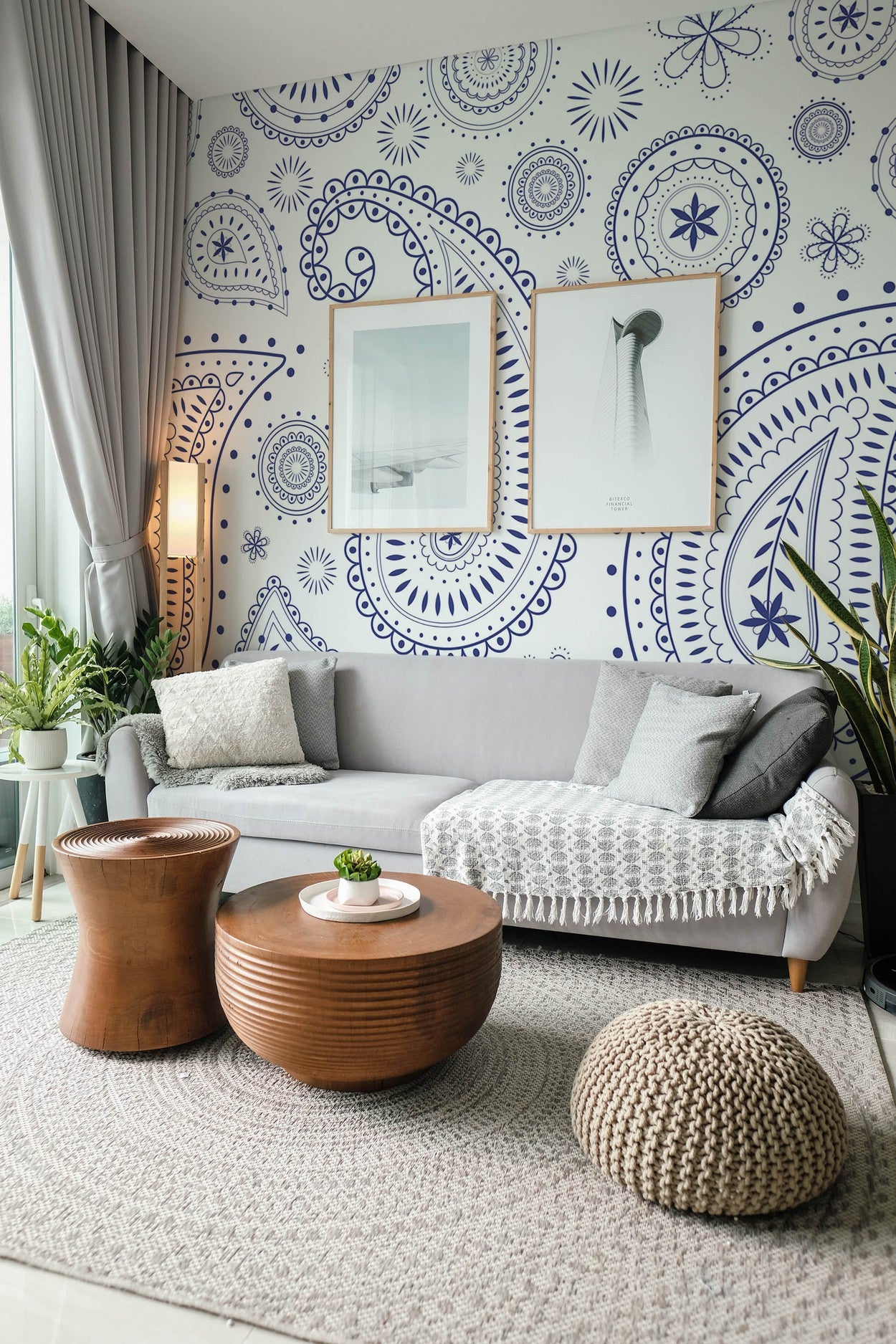 Contemporary living room interior with sofa, wooden furniture, and decorative blue and white wall mural