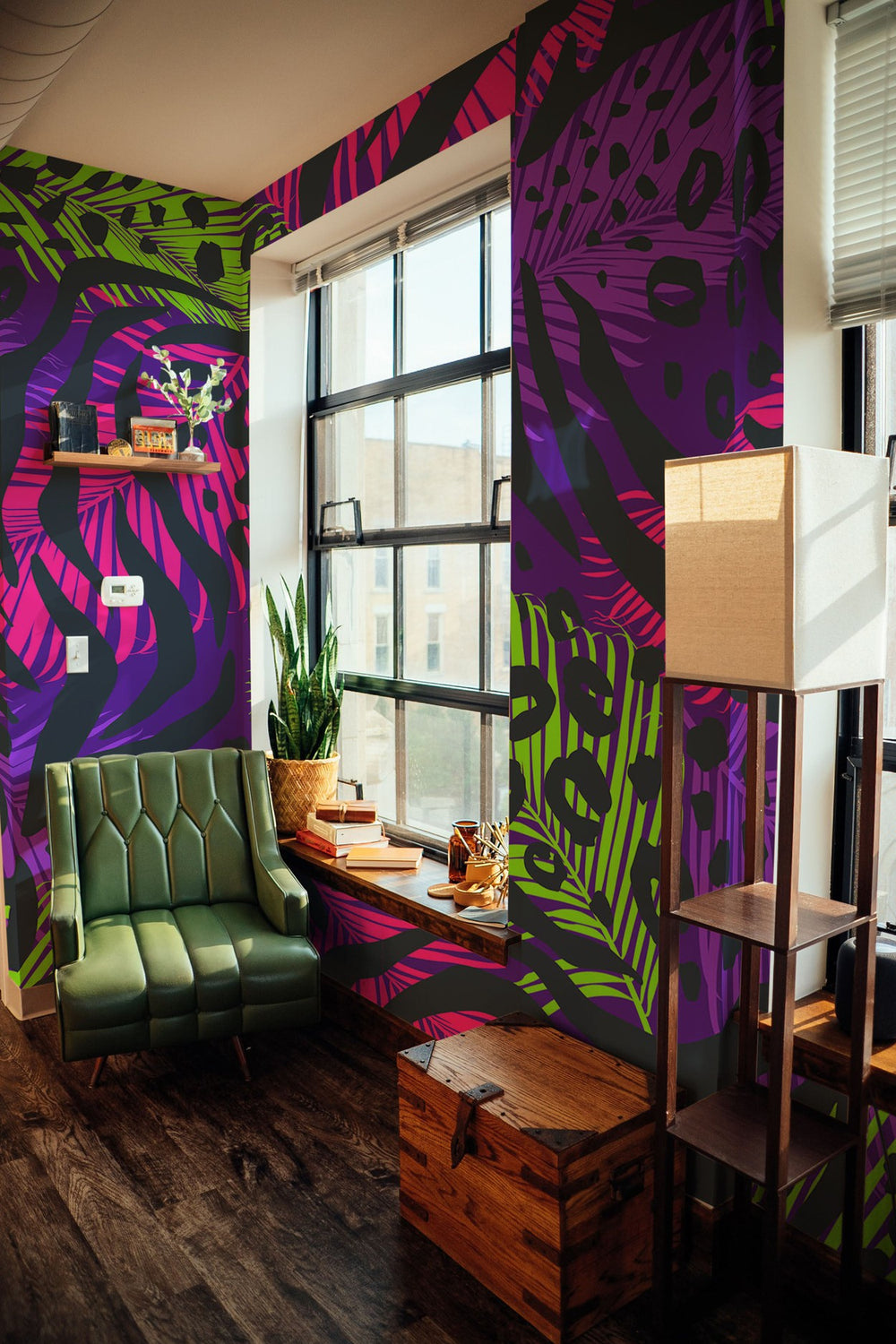 Stylish interior of a living room with a vibrant purple and green wall mural, green sofa, wooden furniture, and houseplants near a window.